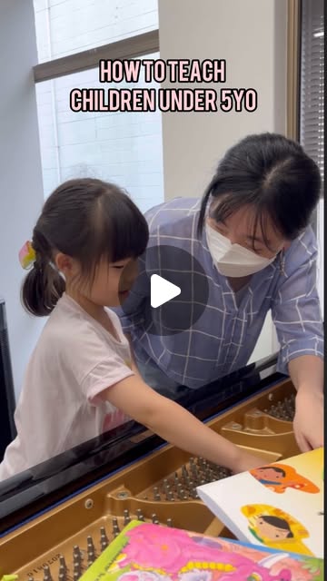 A young student learning piano with a teacher.